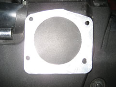 Custom fabricated spacer to use on the OBD1 manifold